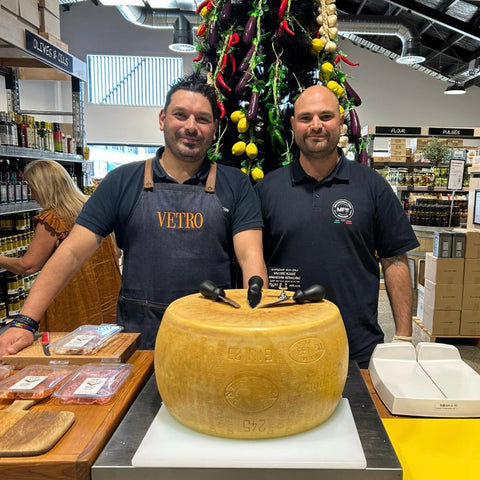 Our sales reps posing with a wheel of Parmigiano Reggiano